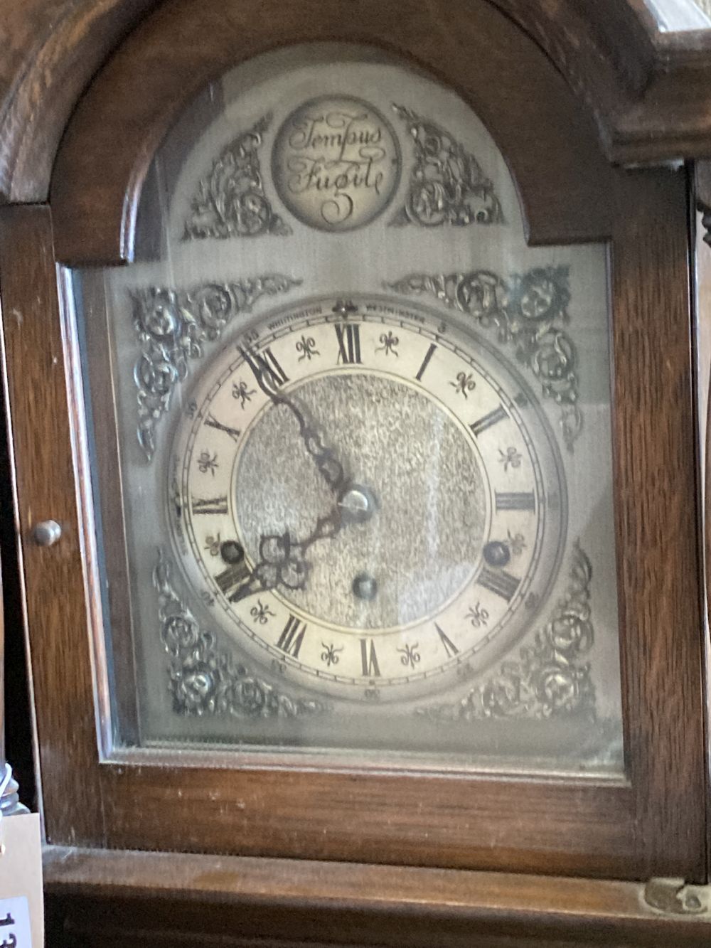 A 1930s/40s oak grandmother clock having Whittington/Westminster chimes, height 176cm